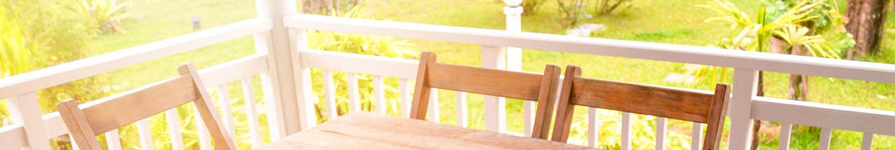 Chairs and table on porch on a sunny day